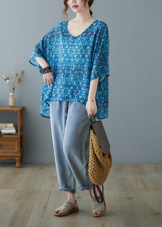 Lose blaue Bluse mit V-Ausschnitt, niedrigem, hohem Design und halblangem Ärmel